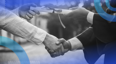 A graduate shakes hands and receives a diploma