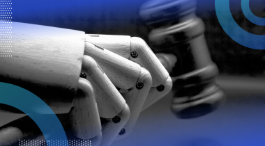 A robot hand holding a gavel