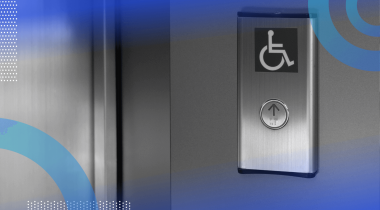 A silver elevator button with the accessibility symbol above it