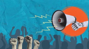 A robot arm holding a megaphone over a crowd of protesters with their fists in the air.