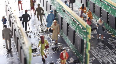 A photo of mini figures walking on a mother board to show the idea of agentic AI.