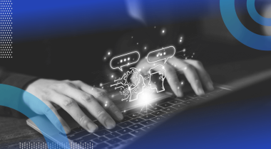 A closeup on a pair of hands on a laptop with two animated heads talking