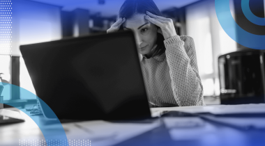 A woman looks frustrated while working on her laptop