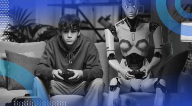 A man sits on a couch playing video games with a robot