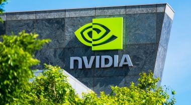 Granite building facade with the Nvidia logo in green, partially blocked by a green tree.