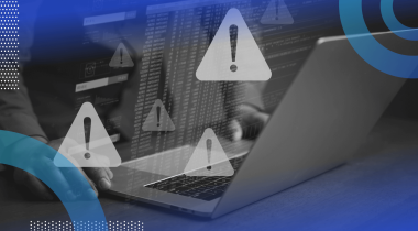 A closeup of hands working on a laptop with warning icon overlays