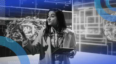 A woman presenting on a stage with a futuristic, high-tech digital background.