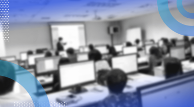A group of people take a training class on computers