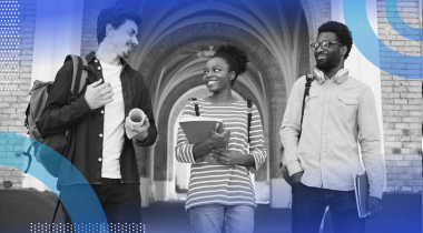 A group of students talk on a campus