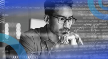 A software developer looks thoughtfully at a computer screen with an overlay of code