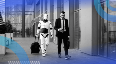 A man in a suit on the street looks at a smartphone while a robot with a suitcase follows him