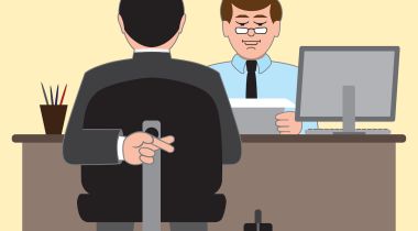 A job applicant crosses his fingers behind his back during a job interview.