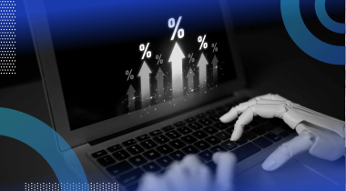 Robotic hands type on a laptop showing bar graphs going up