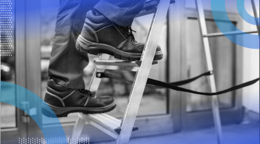 A closeup of a worker in boots climbing a ladder