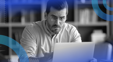 A man looks extremely frustrated while using a tablet computer