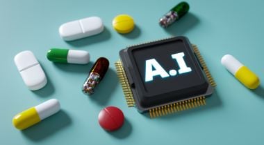 Pills are resting on a turquoise surface, along with a computer chip with "AI" written on it.