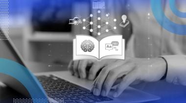 A closeup of hands typing on a laptop with a glowing book with AI concepts above it