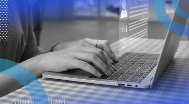 Hands typing on a laptop