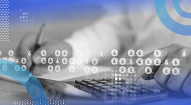A closeup on someone using a calculator and holding a pen