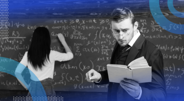 A man reads from a book while a woman does math on a chalkboard