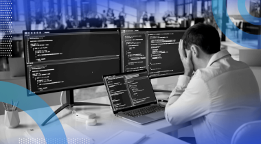 A software engineer looks frustrated while reviewing code