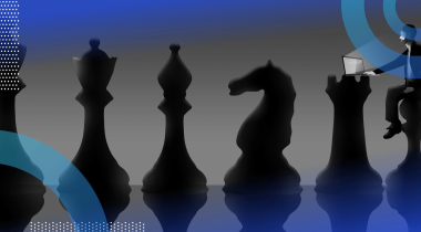 A series of chess pieces with someone sitting on the pawn working on a laptop