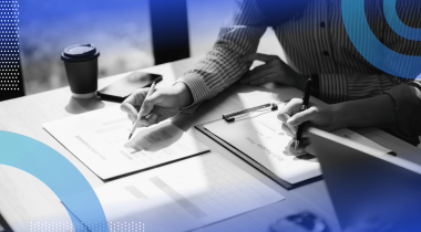Two people work on documents