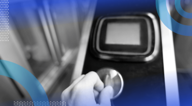 A hand puts a token into a subway turnstile coin slot
