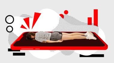 A person lies facedown on a mat.