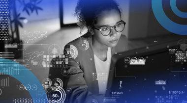 A woman works on a laptop with a data overlay