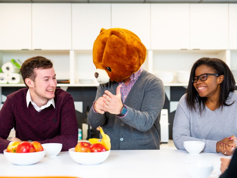 Jennifer Morris sits with a coworker in a bear costume
