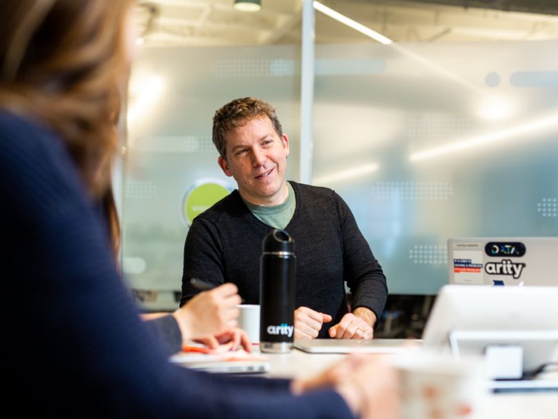 Arity employees in a meeting