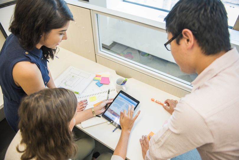 Three Adage Technologies staff working on a project