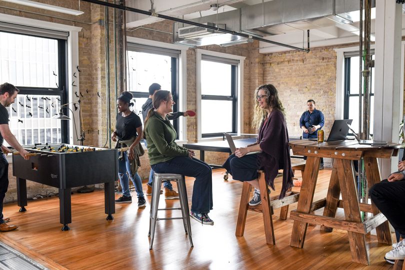 BlackLocus team members in the game room at the office