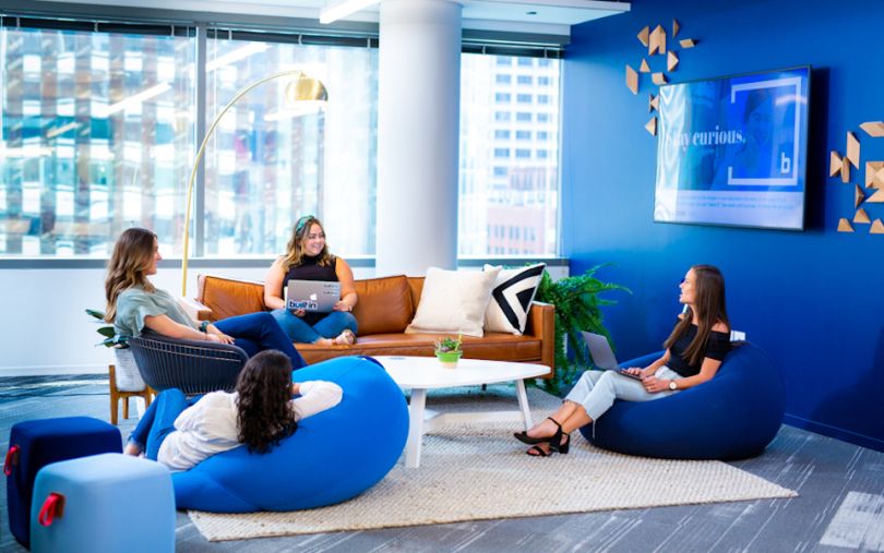 Built In team members chatting on couches