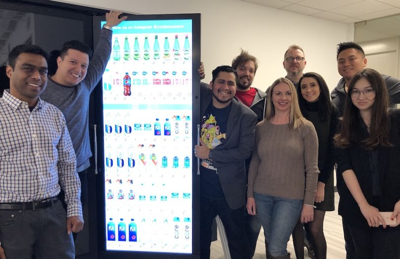 Cooler Screens team standing by retail cooler door