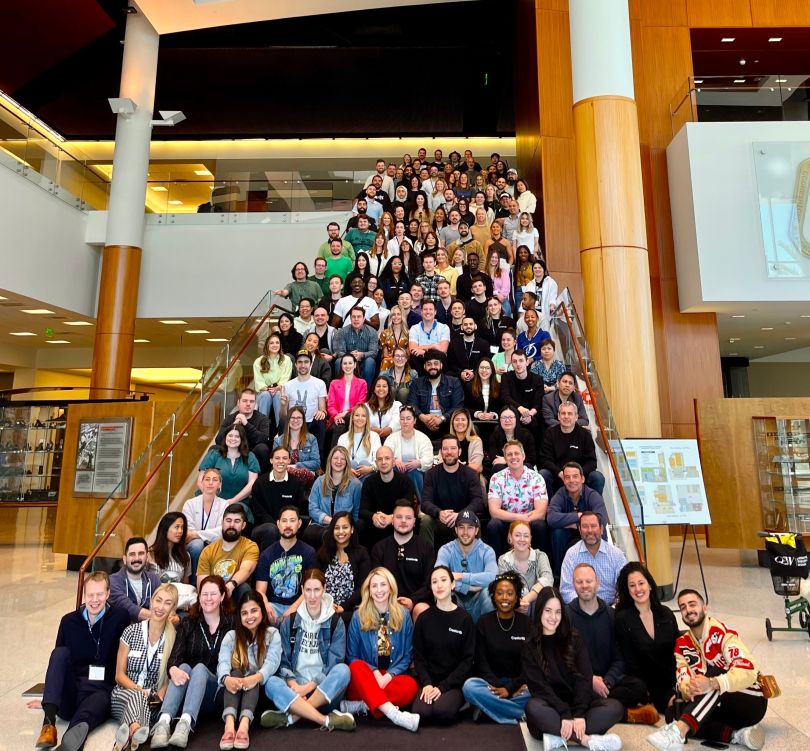 CreatorIQ team members pose for a group photo on a flight of stairs. 