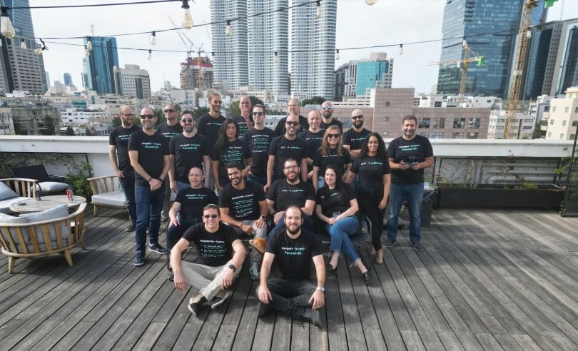 Members of the Descope team pose together on an urban rooftop for a group photo.