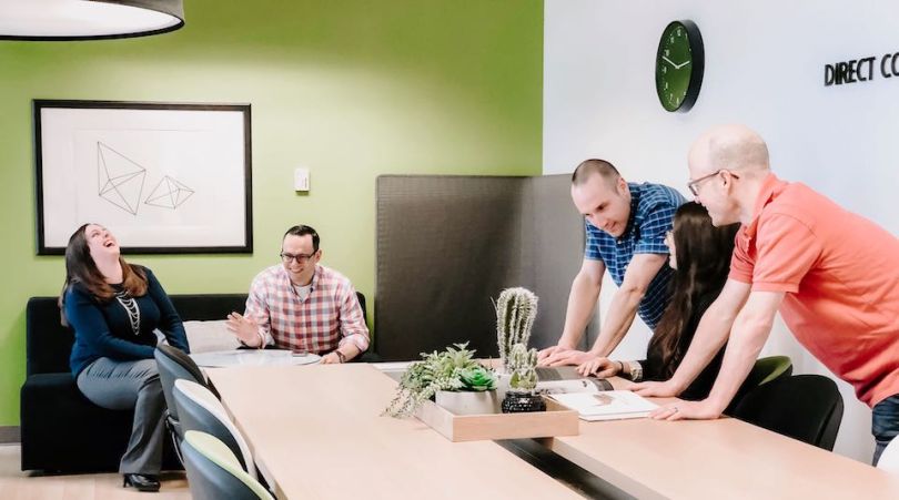 Direct Commerce Group working in a conference room