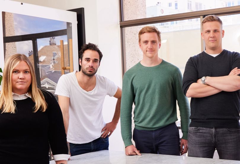 Four members of Kyte’s executive team pose for a group photo in the office.