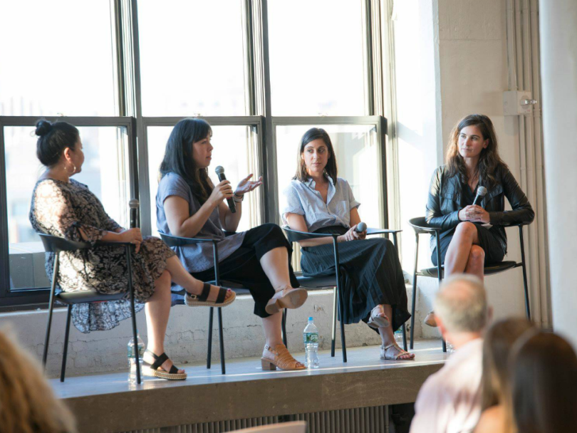 Four women giving a talk on a panel