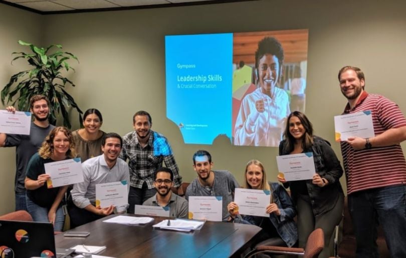 Gympass team holding certificates