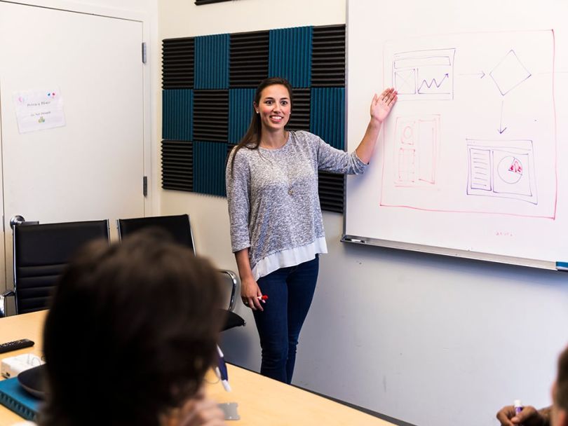 Kimberly, a Technical Product Owner at Catchpoint, collaborates in the office