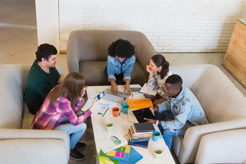 Startup team of young multiracial freelancers or students in the office presenting their ideas
