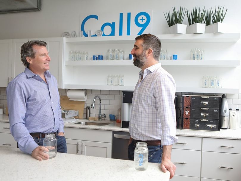 Sylvan Waller talks with an employee in the kitchen.
