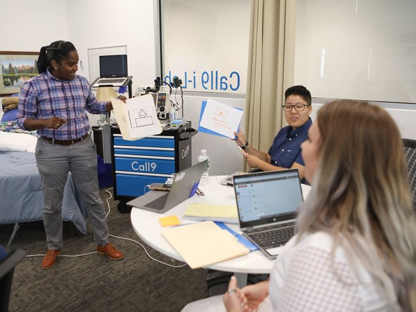 Erika Green trains employees in a lab. 