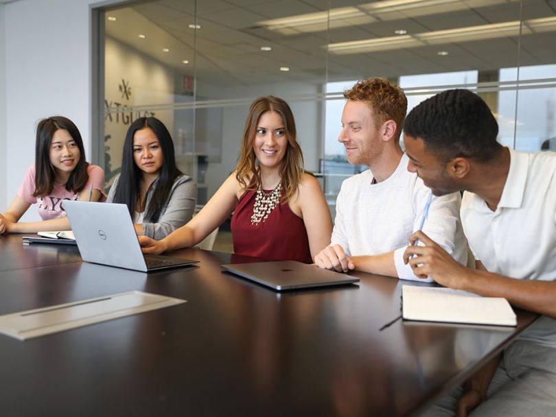 NextGuest works together in a meeting