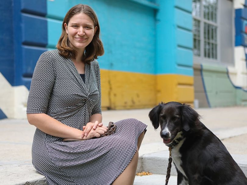 Jess Mink sits with her dog. 