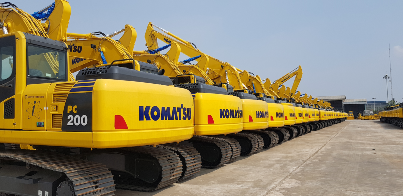 a line-up of yellow Komatsu excavators