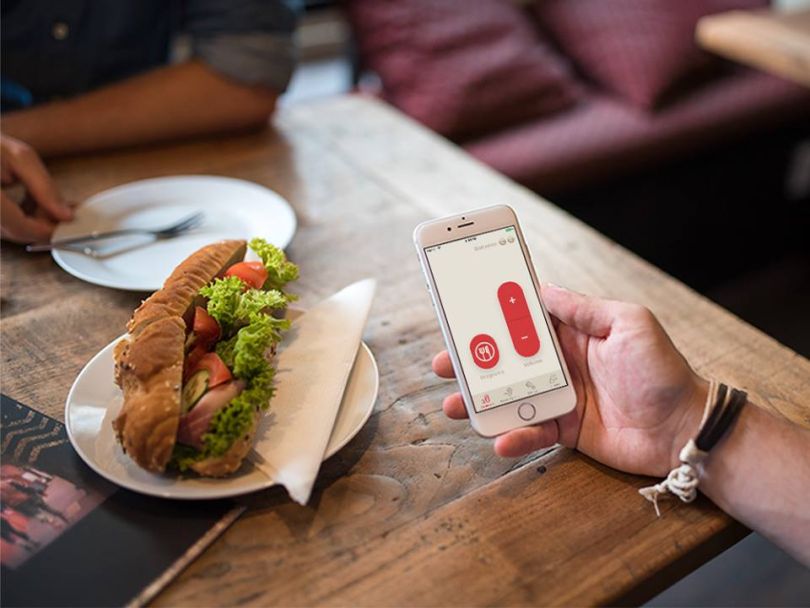 Man using LifeEar app during lunch